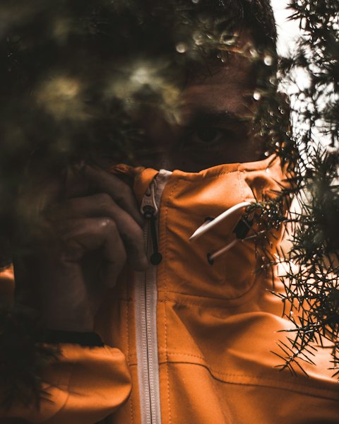 Close-up of a signal orange shell jacket with a black zip