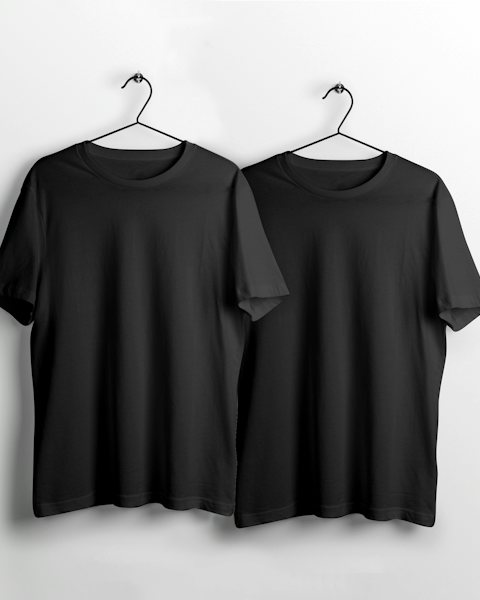 Two black t-shirts on hangers against a white wall